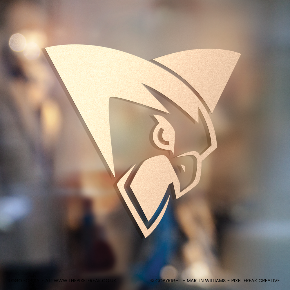 Metallic hawk emblem with a rose gold finish, reflected on a glass surface.